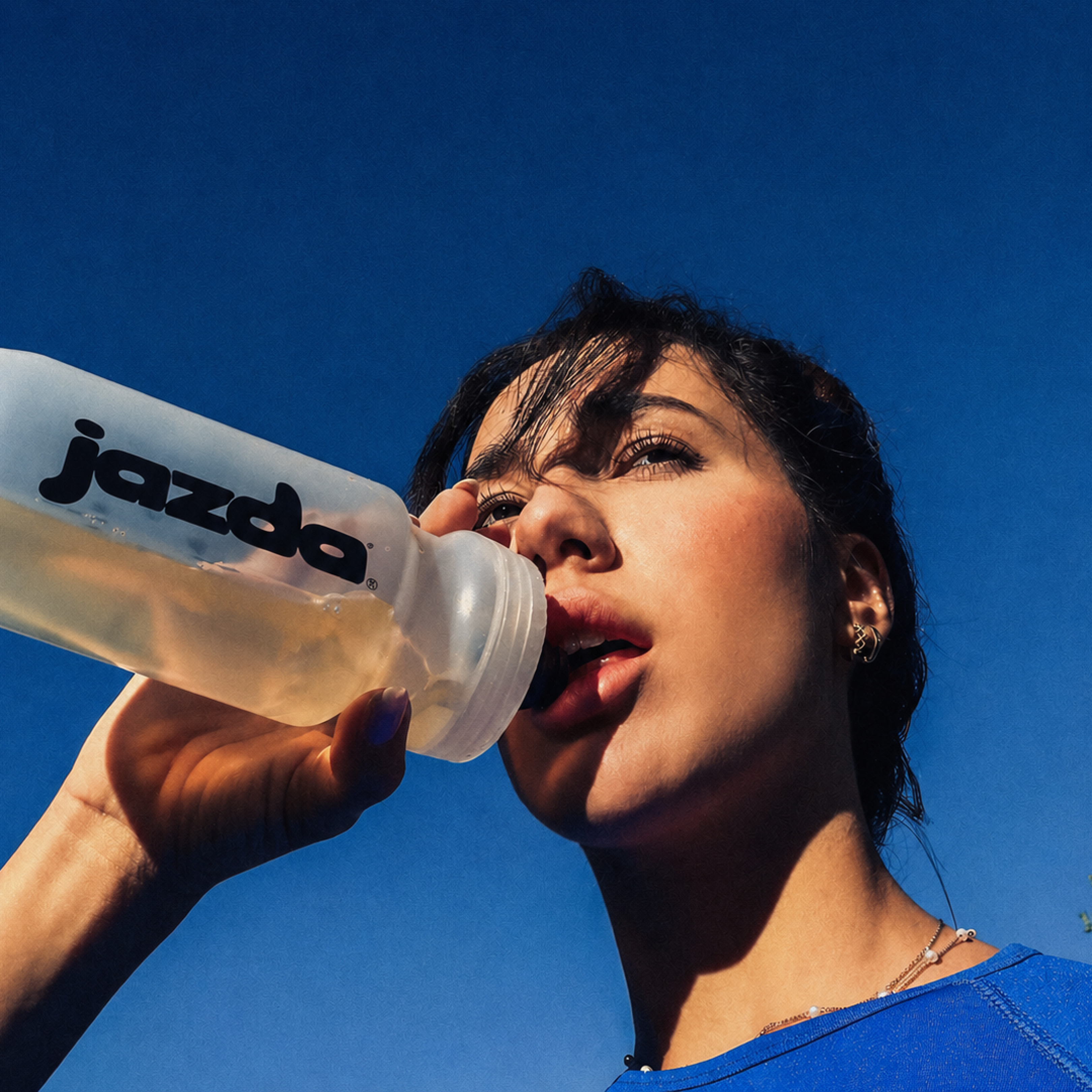Woman gazing through two glasses of water